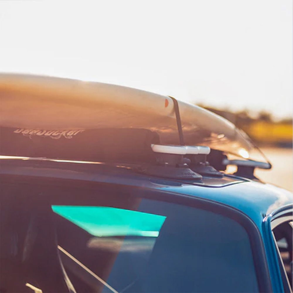 SeaSucker Board Rack for surf and paddle boards with vacuum mounts attached to a car roof, showcasing secure transportation accessories.