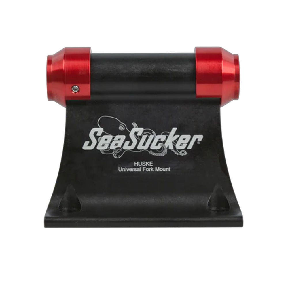 Pair of red SeaSucker HUSKE 20x100mm front hub plugs for bike fork mounts, shown installed on a bike fork.