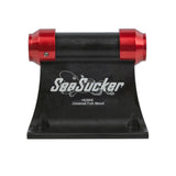 Pair of red SeaSucker HUSKE 20x100mm front hub plugs for bike fork mounts, shown installed on a bike fork.