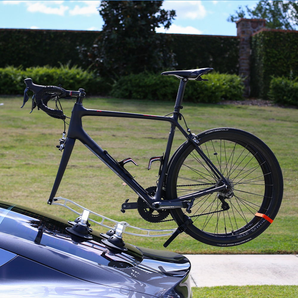 SeaSucker Komodo 1 Bike Rack for sports cars and convertibles, compact roof mount with silver finish, shown installed on a vehicle