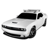 SeaSucker Monkey Bars 60-inch roof cross-bar system for outdoor gear transport, installed on vehicle roof with gear attachments.