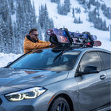 SeaSucker Pallavicini Ski Rack mounted on a car holding two sets of skis and snowboards with lock for secure transport.