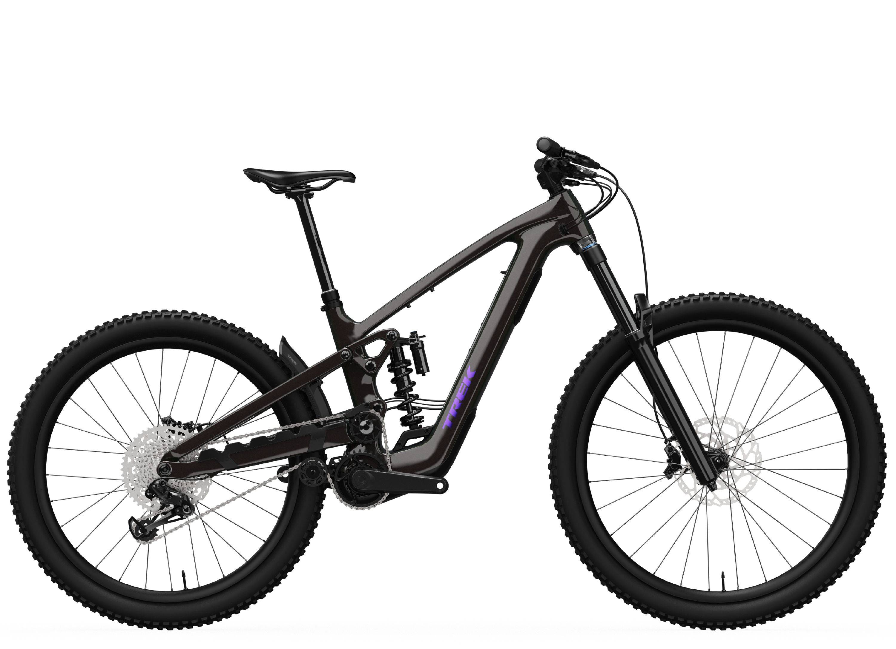 Trek Slash 9.8 XT Di2 Gen 6 mountain bike with high-pivot suspension, black frame, and knobby tires on trail.
