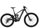 Trek Slash 9.8 XT Di2 Gen 6 mountain bike with high-pivot suspension, black frame, and knobby tires on trail.