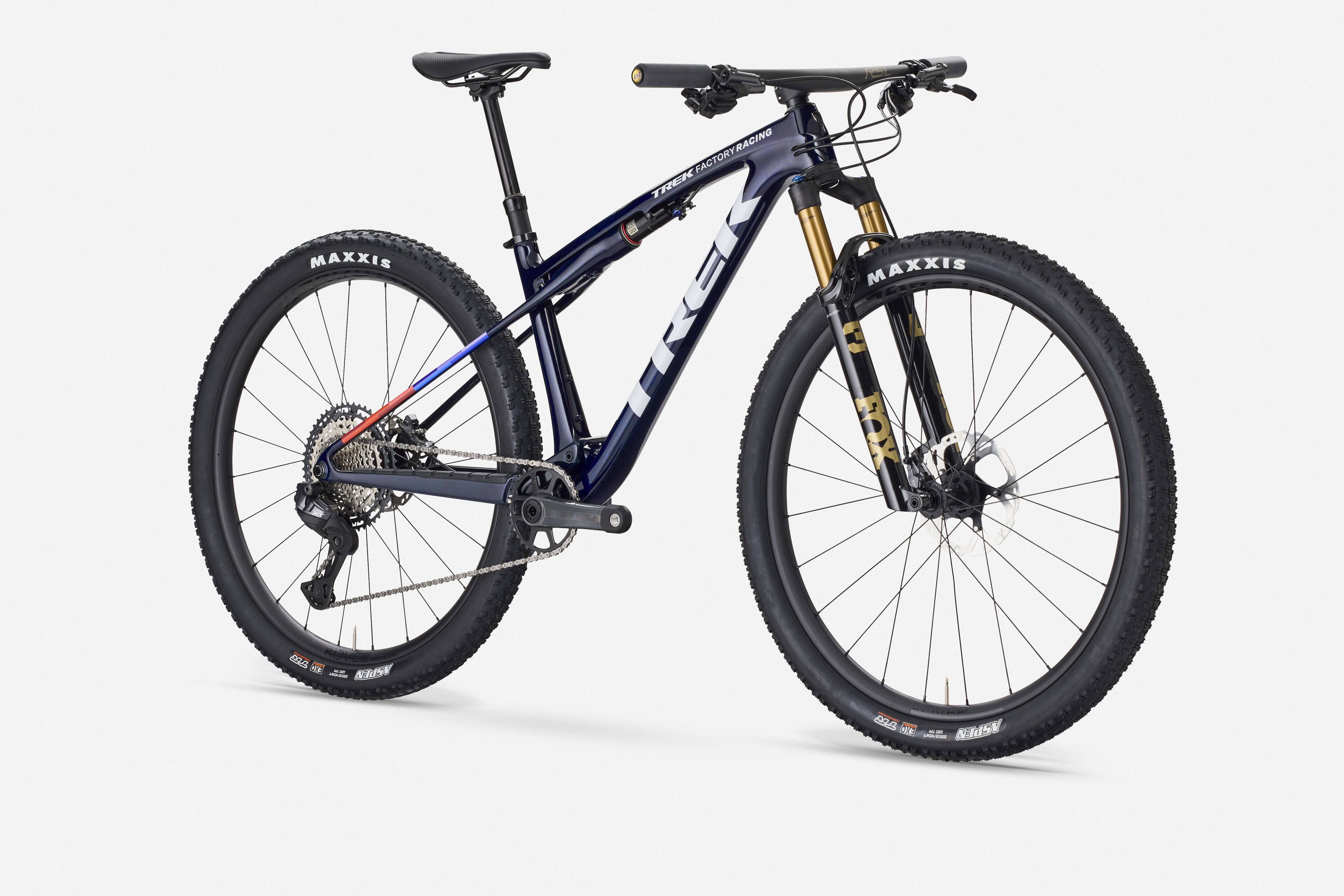Trek Supercaliber SLR 9.8 XT Di2 mountain bike with IsoStrut suspension, featuring sleek frame and advanced gear system.