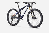 Trek Supercaliber SLR 9.8 XT Di2 mountain bike with IsoStrut suspension, featuring sleek frame and advanced gear system.