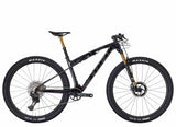 Trek Supercaliber SLR 9.9 XTR Di2 mountain bike with IsoStrut rear suspension, black frame, and high-performance components.