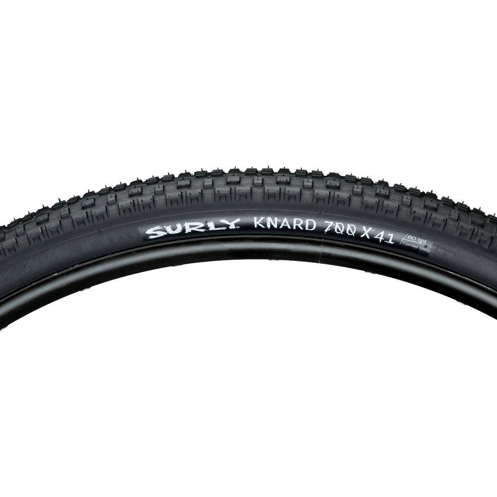 Surly Knard 700x41c tubeless ready mountain bike tire suitable for hardpack and trail riding, shown mounted on a bike wheel.