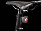 Trek seatpost with matching carbon seatmast cap and 7mm round saddle clamp ears, shown on a bike component.