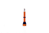 Orange FBI 45mm tubeless valve for secure, airtight seal on tubeless tires, component designed for reliable tire inflation.
