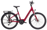 Trek Verve+ 1 Lowstep women's electric hybrid bike with step-through frame and comfortable e-Assist ride, shown in a scenic outdoor setting.