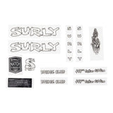 Surly frame and hub adaptor with headbadge for bikes, showing the component and branded headbadge on a neutral background.