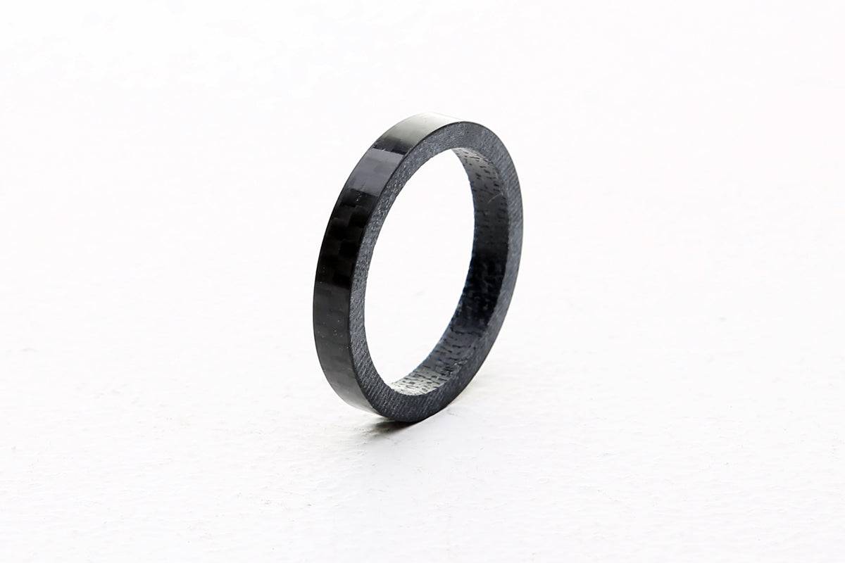 FBI Carbon headset spacer 1 1/8 inch, 5mm thickness, lightweight bike component, shown installed on a bike fork.