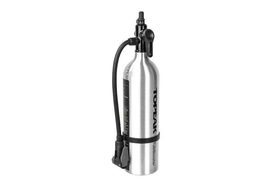 Topeak Tubibooster X Silver tubeless tyre inflator with Presta and Schrader valve compatibility, shown with digital display and fittings.