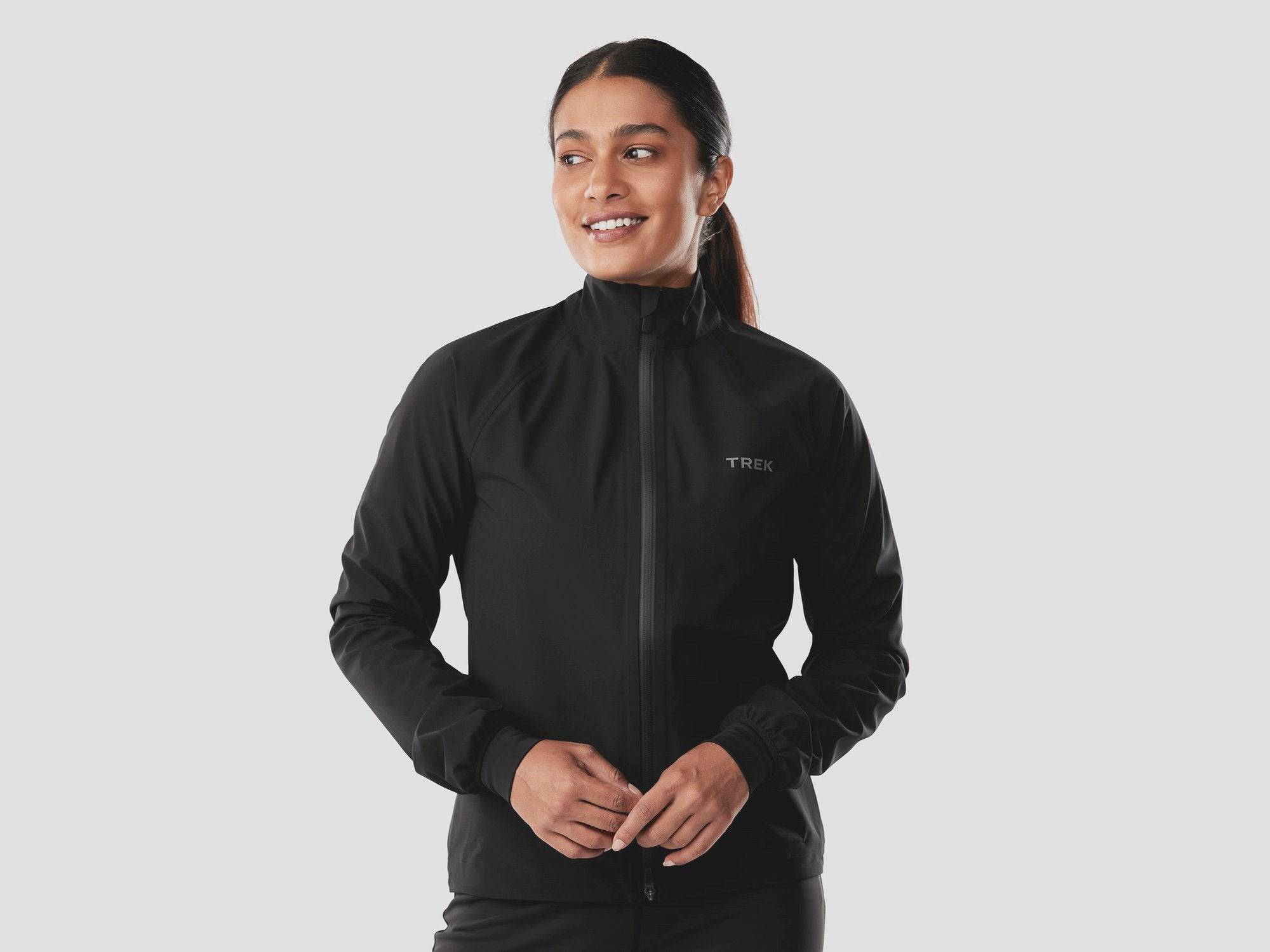 Trek Circuit Women's waterproof rain cycling jacket, lightweight and packable, shown in bright yellow with reflective details.