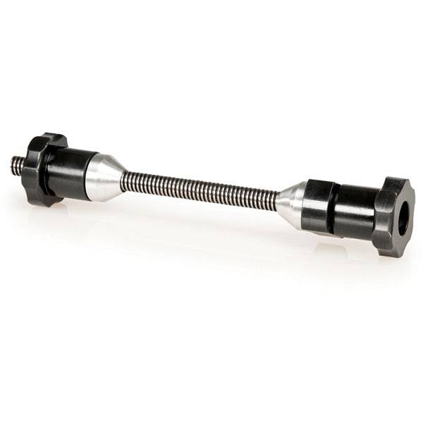 Park Tool TSTA thru-axle adapter for wheel truing stands, fits 12mm, 15mm, and 20mm bike wheel axles in workshop setting.