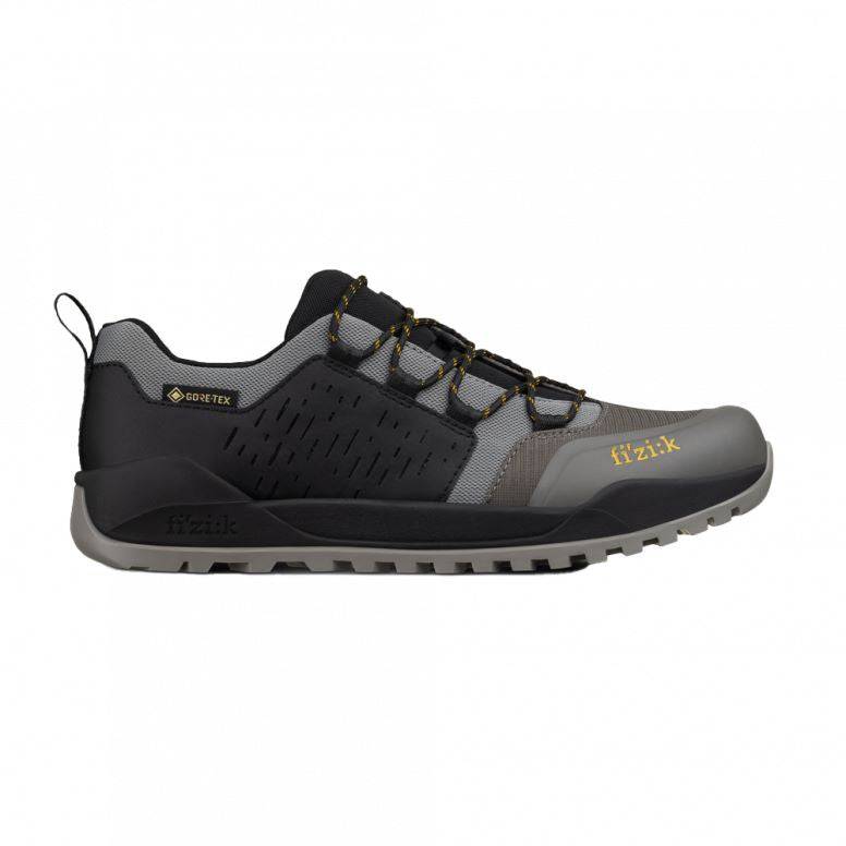 Fizik Terra Ergolace GTX waterproof flat MTB shoes with Vibram outsole, featuring black and gray design and breathable material.