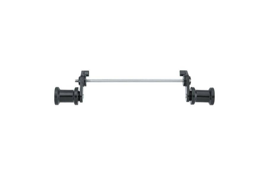 Topeak Journey Trailer QR Hitch quick-release connector in black and silver, shown as a workshop accessory.