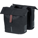 Black Basil City Double Bicycle Bag with reflective panels, water-repellent pannier for 28-32L capacity, ideal accessories for cycling.