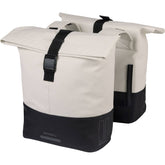 Water-repellent Basil Cove Double Pannier Bag for bikes, shown attached to bicycle, ideal for commuting luggage.