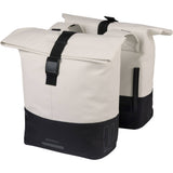 Water-repellent Basil Cove Double Pannier Bag for bikes, shown attached to bicycle, ideal for commuting luggage.