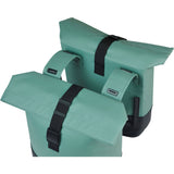 Basil Cove double pannier bag attached to a bicycle, water-repellent bike luggage for commuting, with reflective details.