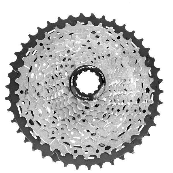Shimano Deore XT CS-M8000 11-speed MTB cassette with Hyperglide for smooth shifting, shown with metal sprockets and gear teeth.