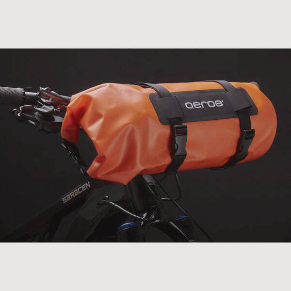 Aeroe Spider Handlebar Cradle bike mount for carrying extra gear, shown attached to a bike handlebar with gear secured.