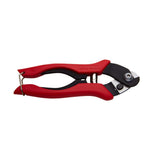 SRAM cable housing cutter tool with awl for precise bike cable maintenance, shown with cutting blade and handle in a workshop setting.