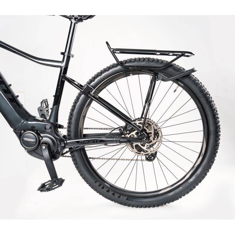 Topeak Tetrarack M2 HD black rear bike rack with QuickTrack™ system mounted on a bicycle for carrying cargo.