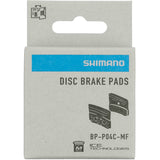 Shimano XTR P04C-MF metal sinter disc brake pads with cooling fins and spring, component for mountain bike braking systems.