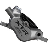 Shimano XTR BR-M9220 4-Pot hydraulic disc brake caliper for front or rear mountain bike, mounted on a bike frame.