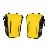 Burley waterproof bike pannier set with reflective patches and carry handles, designed for durability and visibility.