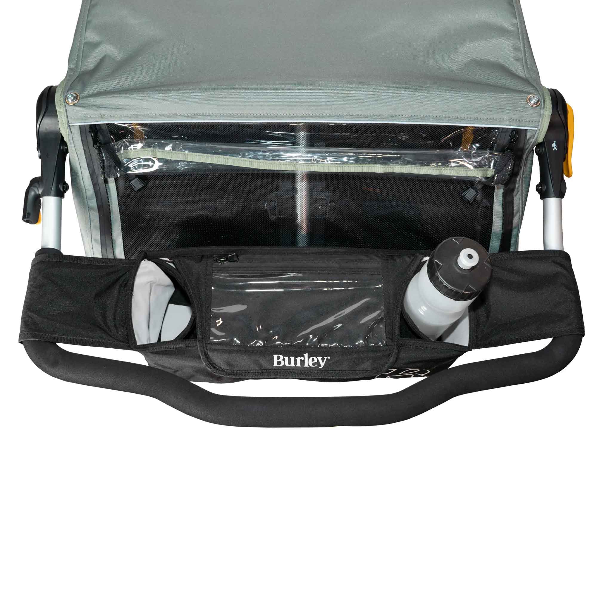 Burley handlebar console with cup holders and clear phone pocket for trailers, mounted on bike handlebars.