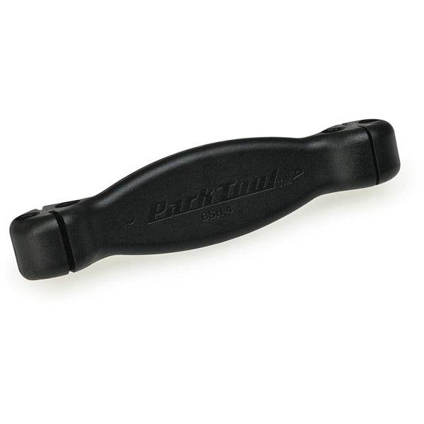 Park Tool BSH-4 bladed spoke holder for precision wheel building and maintenance, shown in a workshop setting.