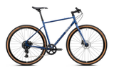 Genesis Croix de Fer 10 flat bar gravel bike with Shimano 1x9-speed drivetrain and hydraulic brakes, shown in a detailed side view.