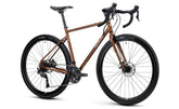 Genesis Croix de Fer 10 gravel bike with Shimano Cues 2x9-speed drivetrain, featuring a sturdy frame and off-road tires.