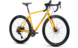 Genesis Croix de Fer 30 2026 gravel bike with Shimano 10-speed drivetrain and hydraulic disc brakes, shown from the side on a trail.