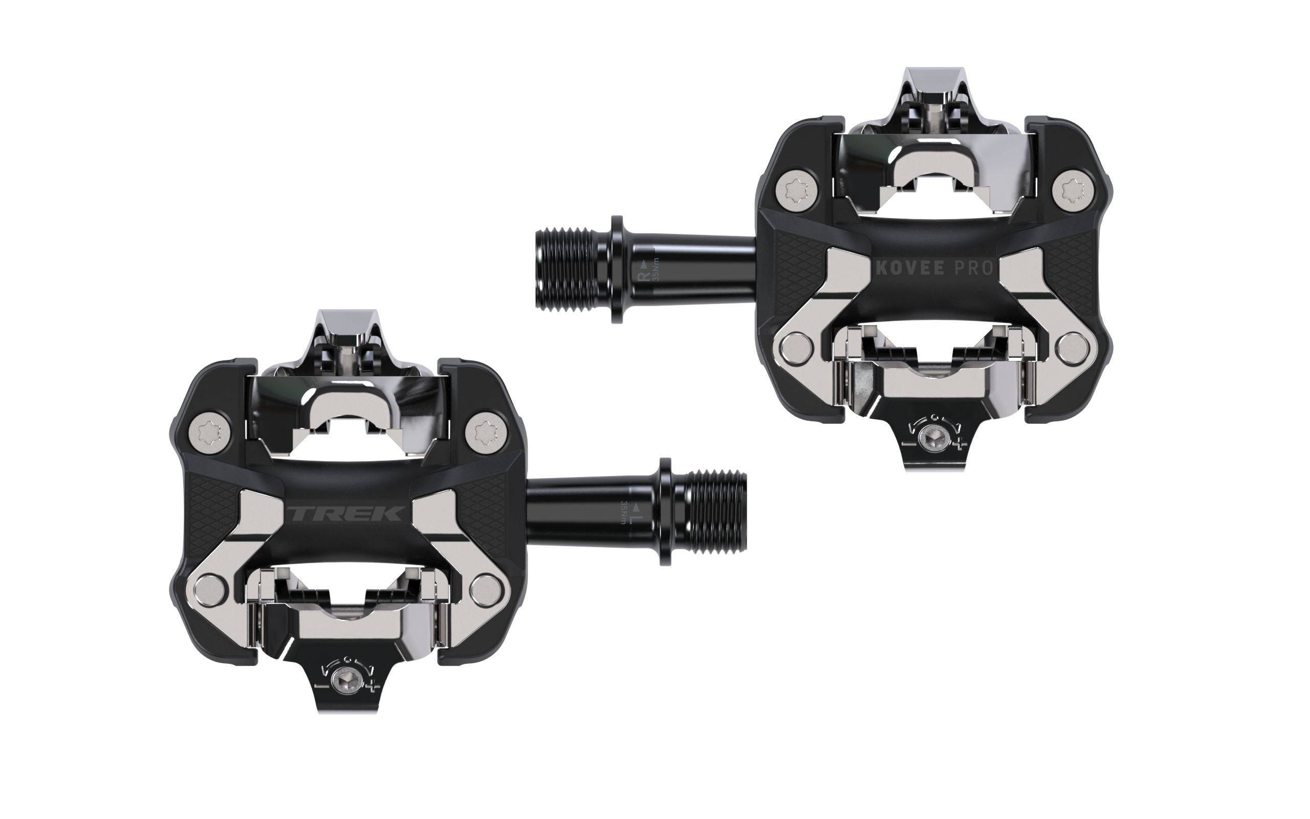 Trek Kovee Pro black clipless pedal set with 9/16" spindle, suitable for road and mountain biking, mounted on bike crank.