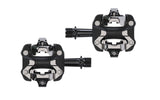 Trek Kovee Pro black clipless pedal set with 9/16" spindle, suitable for road and mountain biking, mounted on bike crank.
