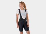 Trek Solstice women's eco-friendly cycling bib shorts with padding and support, shown on a model with a close-up view of the fabric