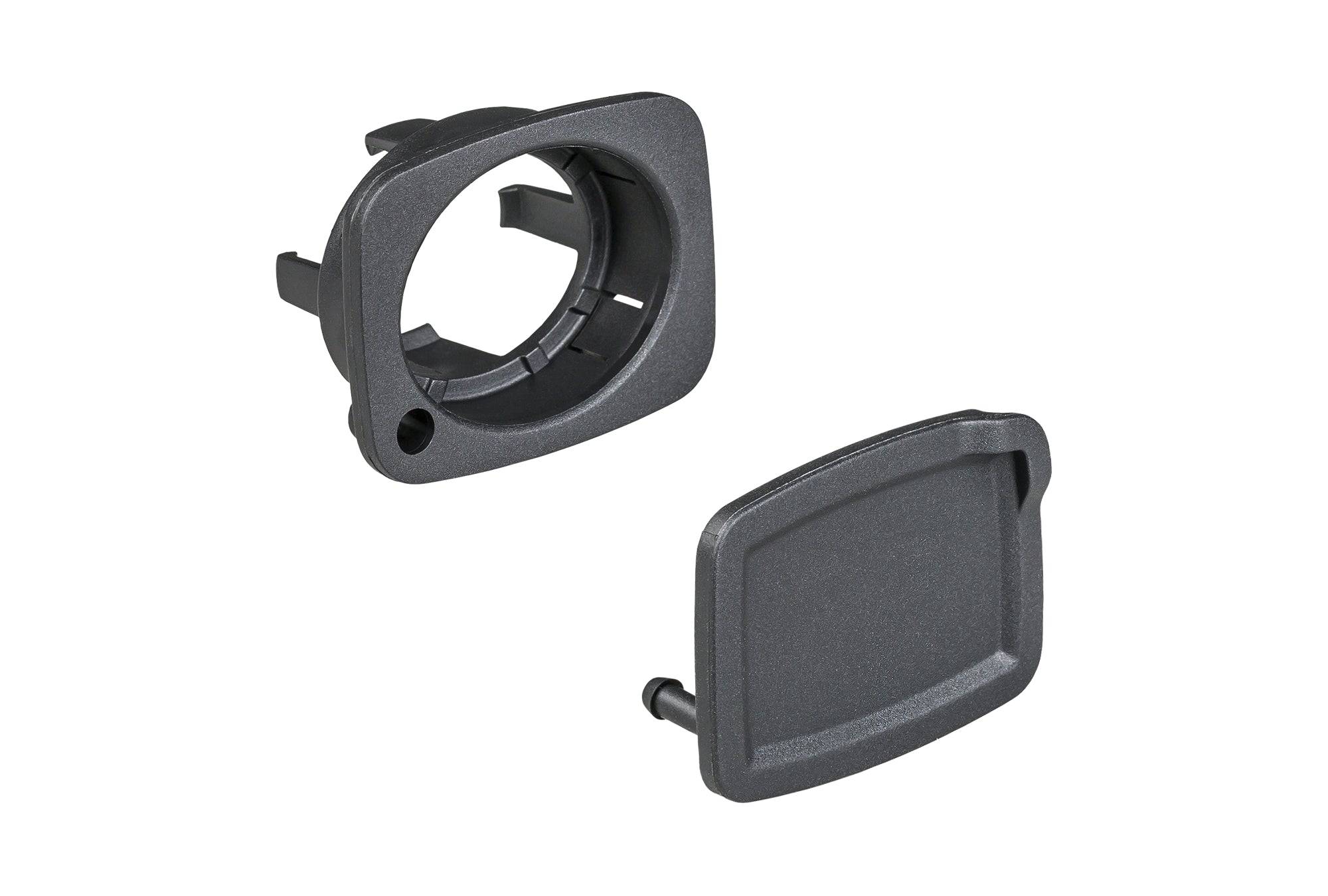 Black Trek E-Bike charge port cover for battery protection and dust guard, component for Trek electric bike batteries.