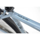 Genesis Tour De Fer 30 adventure bike with disc brakes, designed for long-distance touring, 2025 model, shown in a scenic outdoor setting.