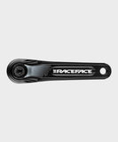 Race Face AEffect 137mm MTB crank arms with Cinch system, black component for trail riding, shown in close-up image.