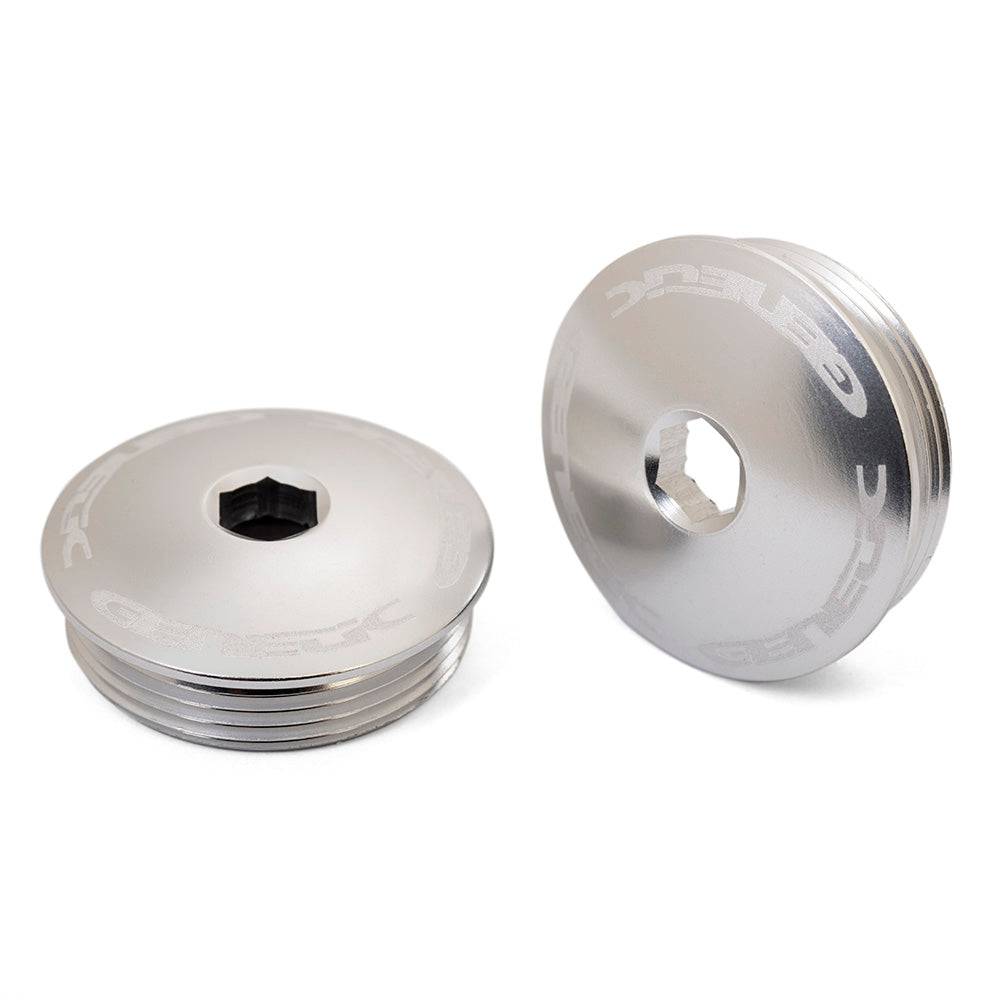 Genetic Heritage Crank Caps spare parts and accessories for bike axle protection, shown in black with metal finish.