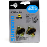 Shimano SH56 MTB SPD cleats for open design pedals, multi-release cycling components with no cleat nuts, shown on a bike pedal.