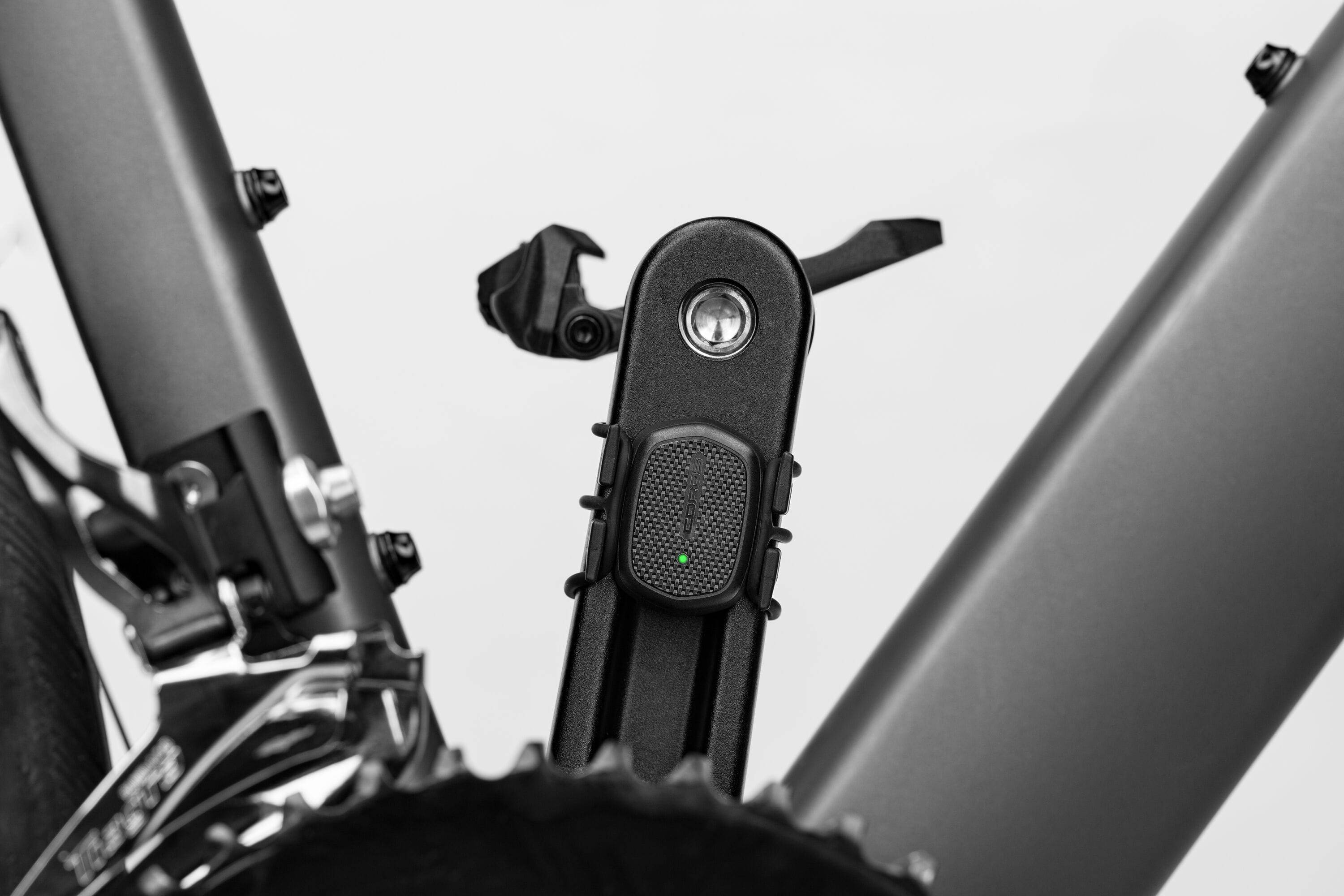 Coros Bike Cadence Sensor mounted on bike crank arm, Bluetooth-enabled, IP67 waterproof accessories for cycling performance tracking.