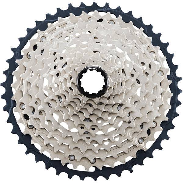 Shimano SLX CS-M7100 12-speed MTB cassette with Hyperglide sprockets showing gear teeth and compact design.