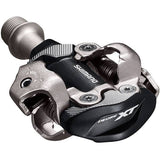 Shimano Deore XT PD-M8100 XC Race SPD pedals with adjustable tension and mud shedding for mountain biking.