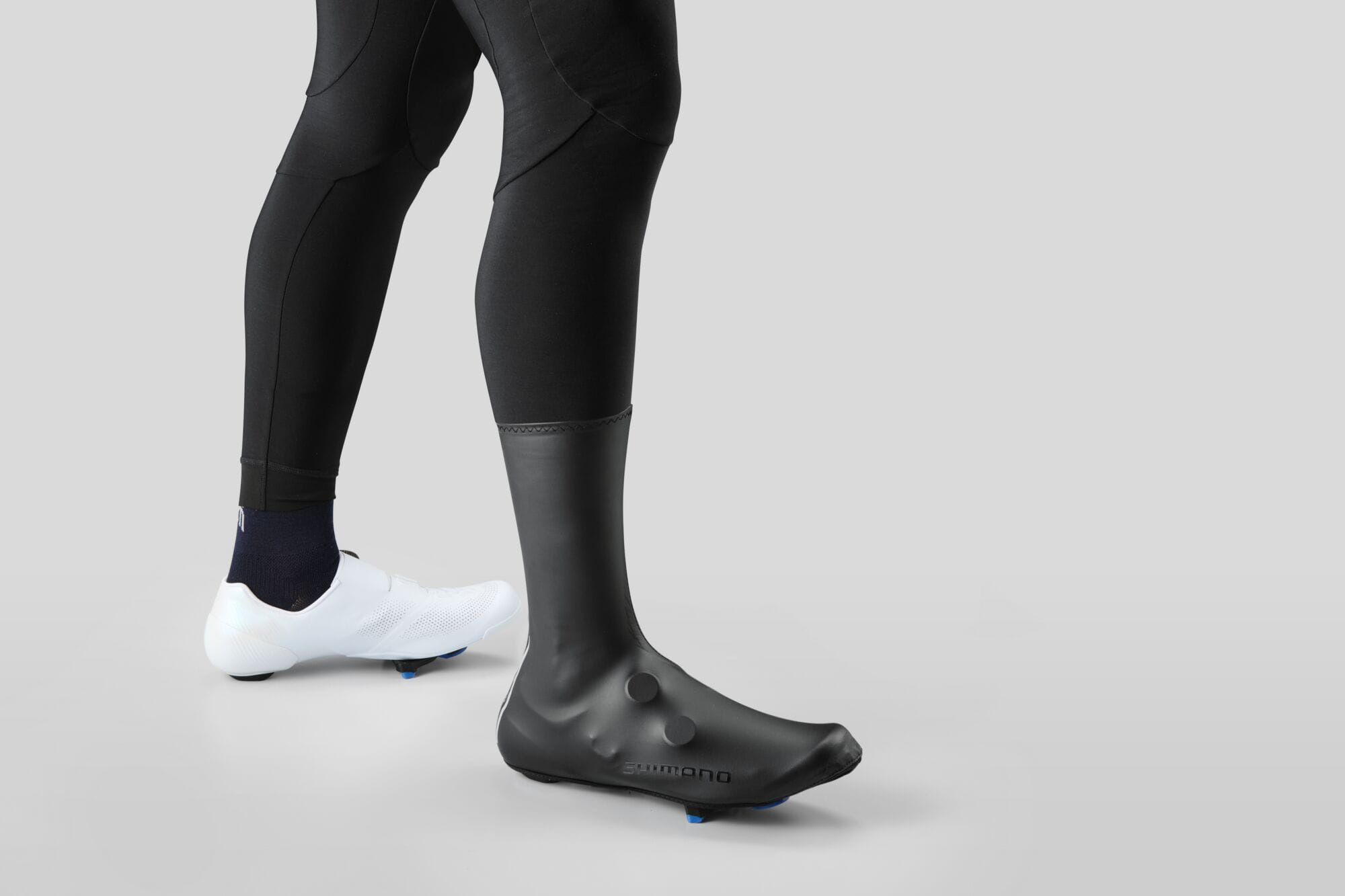 Shimano Unisex Dual Fit rain shoe cover with SplashShield technology for cycling, shown on a shoe with reflective detailing.